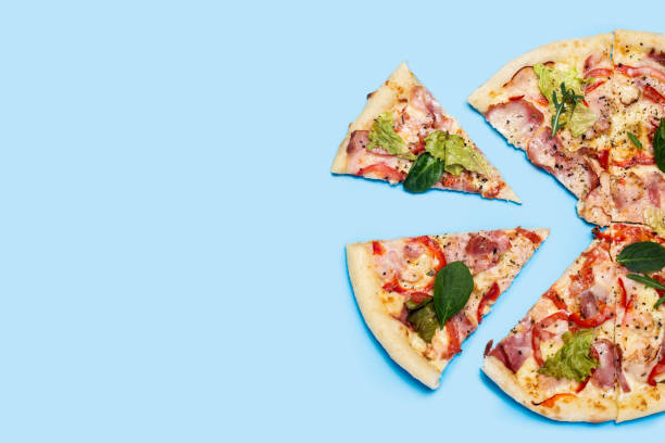 istock cut pizza fresh hot on a blue background. Top view, flat lay 1318165572