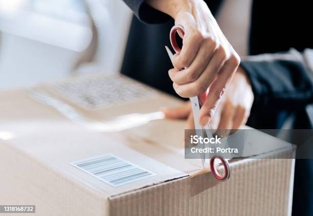 Closeup Of A Woman Opening Her Courier Parcel Stock Photo - Download Image Now - Unboxing, Box - Container, Package