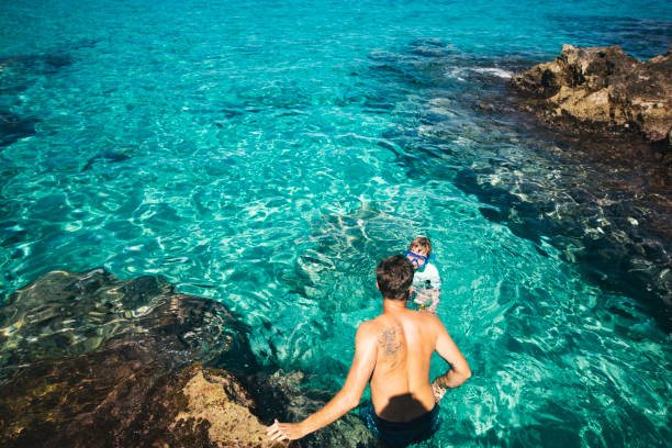 istock Father and son swimming 1318169664