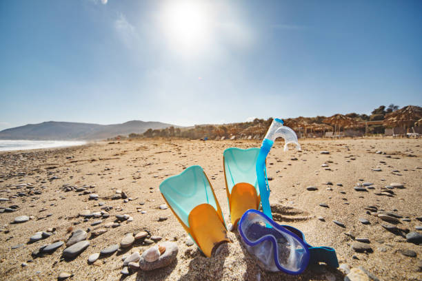 Diving and snorkelling equipment on beach sand