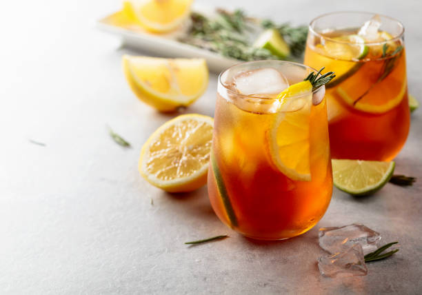 istock Iced tea with lemon, lime and ice garnished with rosemary twigs. 1318169762