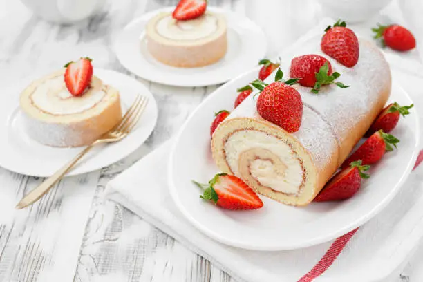 Tasty roll cake stuffed with cream cheese ,decorated with fresh strawberry