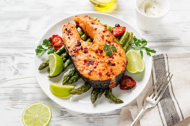 istock Grilled salmon steak with asparagus and tomatoes cherry 1318172590