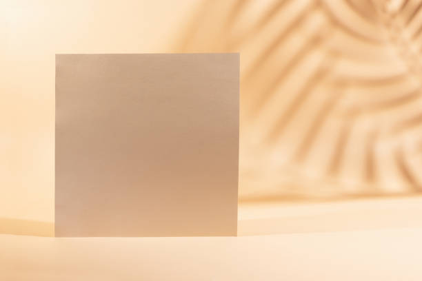 istock Gold Paper sheet or blank card on beige background. 1318174305