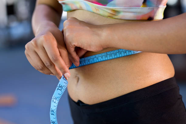 istock Woman measuring waist 1318175445