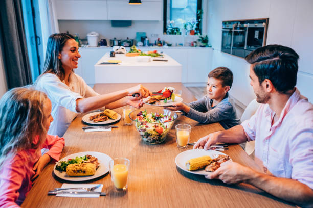 istock Young family enjoying dinner together. 1318178038