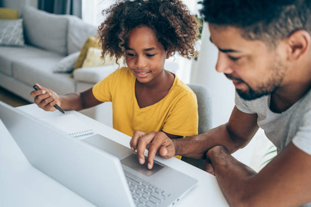 istock Father and daughter studying online at home. 1318178049