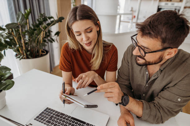 Couple at home Young couple at home loan stock pictures, royalty-free photos & images