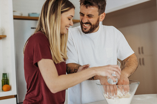 Young couple preparing food in the kitchen