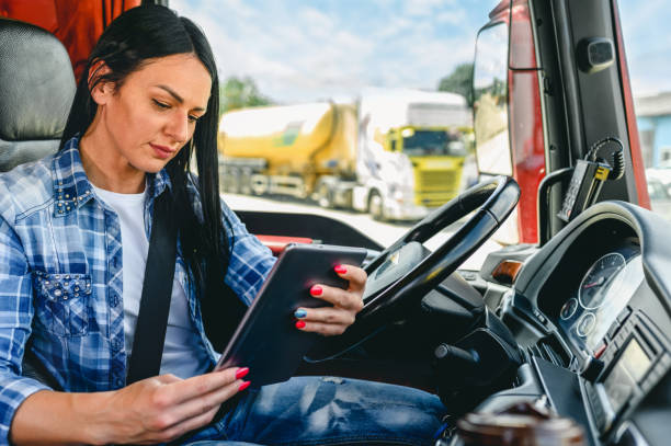 istock Female truck driver using a mobile app 1318188934