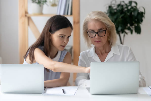 istock Diverse female colleagues work on laptops brainstorming 1318189961