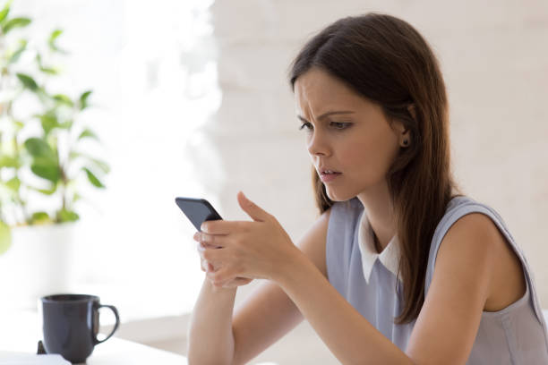 istock Unhappy young woman frustrated by bad message on cell 1318190019