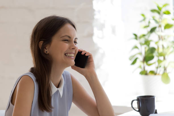 istock Smiling young woman use cellphone talk on gadget 1318190028