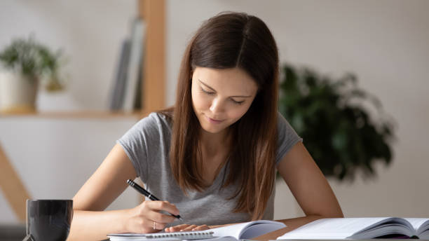 istock Smart teenager study with books at home 1318190030