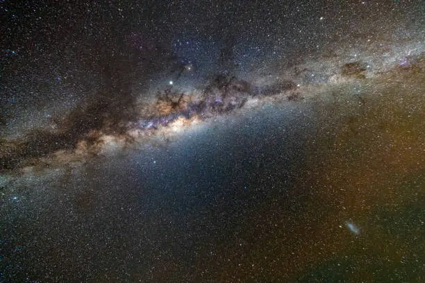 Our home, the Milky Way, with its Galactic Core bright during the night over the horizon at the Sagittarius constellation and in the center the big black hole on the galactic core