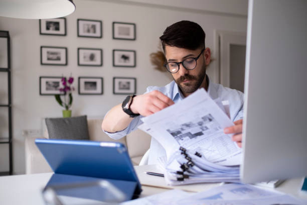 istock Young man working at home in the evening 1318191290