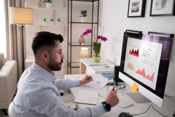 istock Young man working at home in the evening 1318191468