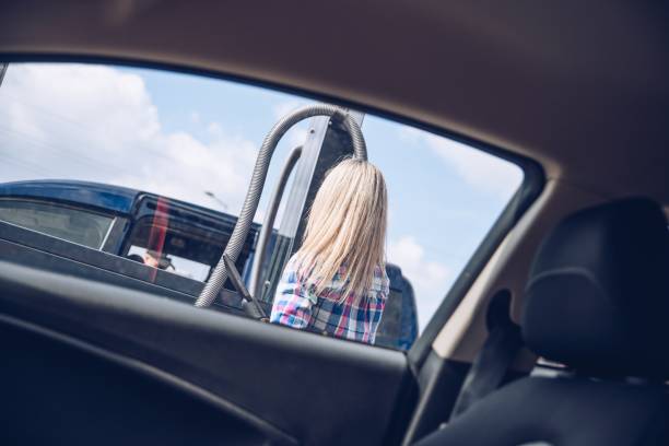 istock Woman paying coins to self service automatic car vacuum machine. 1318193356