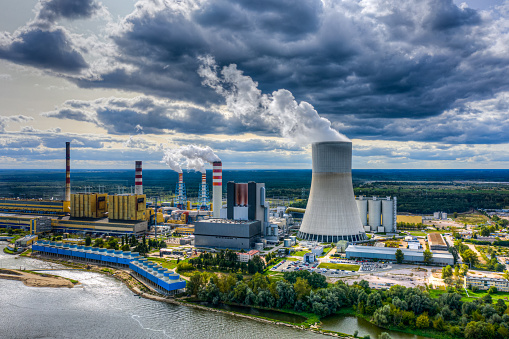 Power station under moody cloudy sky aerial view