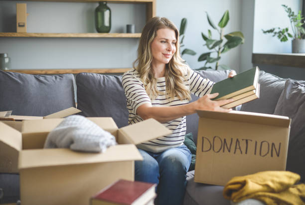 istock woman puts donations in a box 1318196760