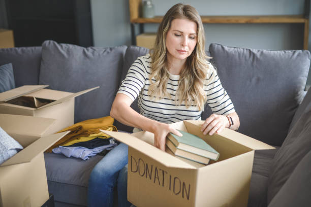 istock woman puts donations in a box 1318197372