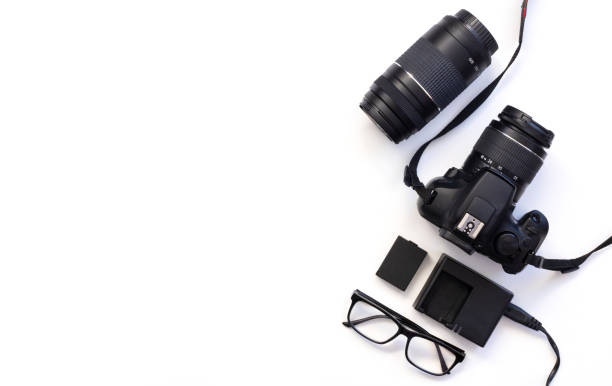 istock top view of work space photographer with digital camera, lens, glasses, camera accessory on white table background 1318200337