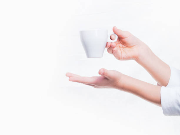 hands with an espresso Cup on a white background