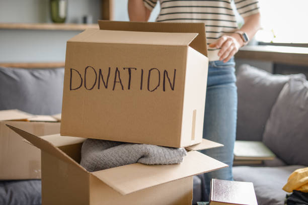 istock woman puts donations in a box 1318204771