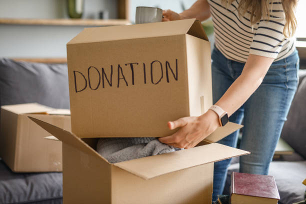 istock woman puts donations in a box 1318204802
