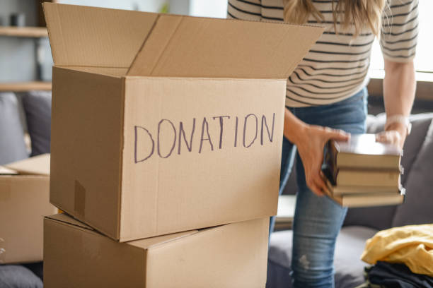 istock woman puts donations in a box 1318204837