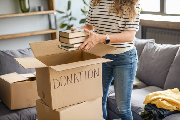 istock woman puts donations in a box 1318204873