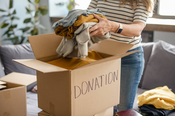 istock woman puts donations in a box 1318205468