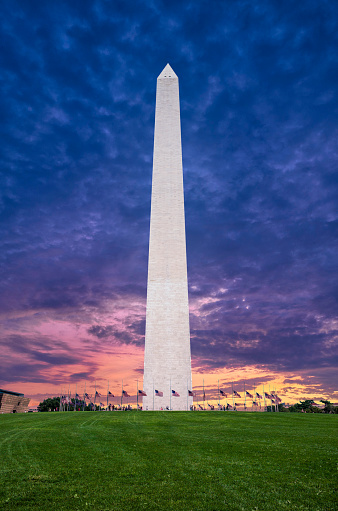The Washington Monument during a deep purple sunset at night.