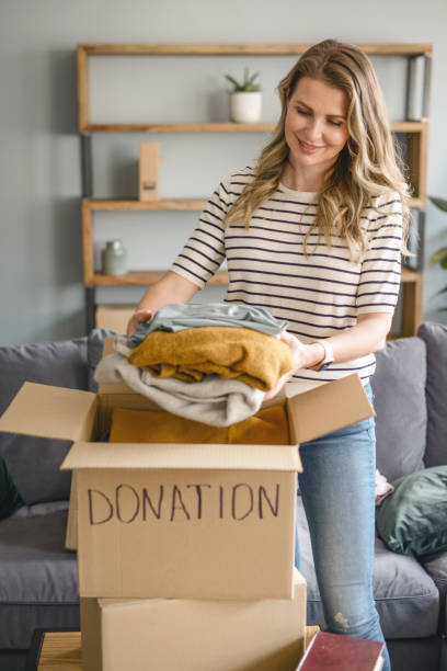 istock woman puts donations in a box 1318205695