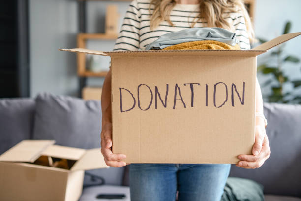 istock woman puts donations in a box 1318205901