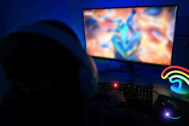 istock Gamer concentrated using computer for playing game. New technology game trends and entertainment concept 1318208004