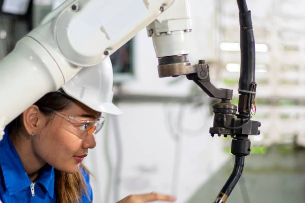 istock Woman mechanic repairing a robot machine. 1318220566
