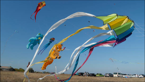 istock Kites flying in clear blue sky. Childhood fun. 1318237103