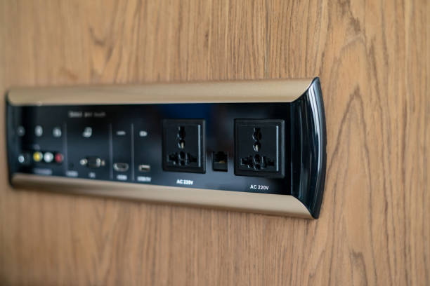 istock Electrical wall socket adapter, plug power outlet and USB charger socket on the wooden wall. 1318238108
