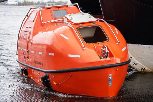 Tanker Version Fire Resistant Totally Enclosed Lifeboat float near big vessel