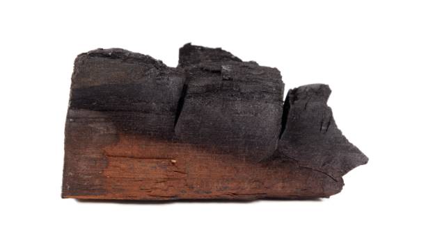 istock Wood charcoal isolated on white background 1318240571