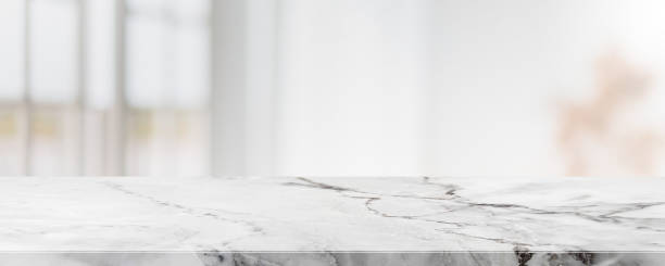 istock Empty white marble stone table top and blur glass window interior cafe and restaurant banner mock up abstract background - can used for display or montage your products. 1318241461