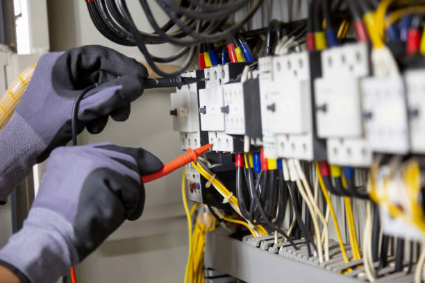 istock Electrician engineer tests electrical installations and wires on relay protection system. Adjustment of scheme of automation and control of electrical equipment. 1318241614