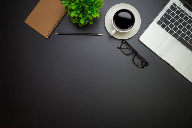 istock Workspace - Flat top view illustration of a workspace with a coffee cup and notebook on the black desk surface,Office desk concept. 1318241631