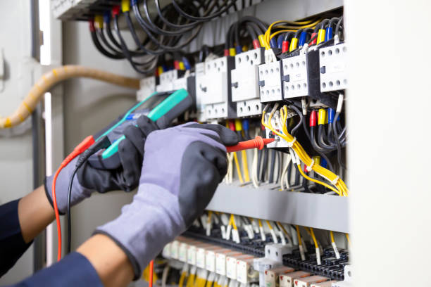 istock Electrician engineer tests electrical installations and wires on relay protection system. Adjustment of scheme of automation and control of electrical equipment. 1318241639
