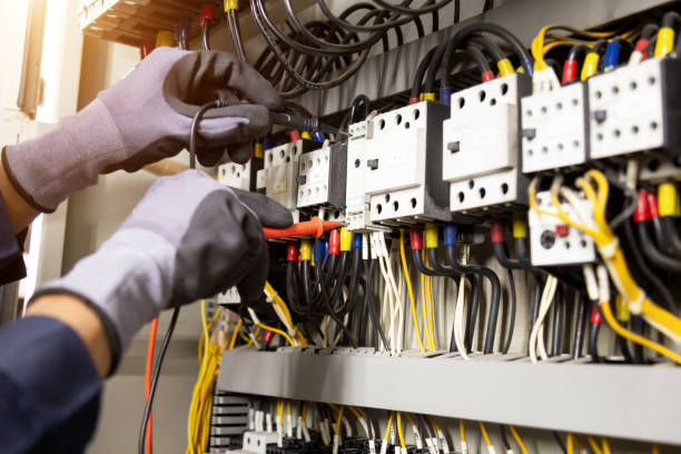 istock Electrician engineer tests electrical installations and wires on relay protection system. Adjustment of scheme of automation and control of electrical equipment. 1318241664