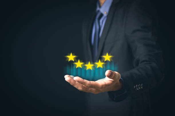 istock Customer Service and Satisfaction Concept Businessmen touch the virtual screen on happy smiley icons to achieve service satisfaction and feedback with excellent rated reviews. 1318241669