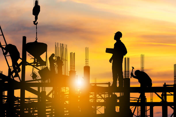 istock Silhouette of Engineer and worker on building site, construction site at sunset in evening time 1318250468
