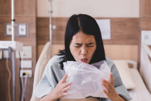Asian woman patient puke or vomiting into plastic bag at hospital,Nausea,Indigestible Asian woman patient puke or vomiting into plastic bag at hospital,Nausea,Indigestible puke stock pictures, royalty-free photos & images