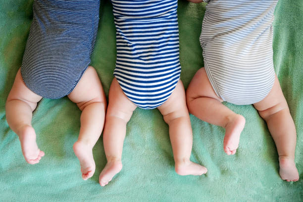 istock Newborn triplets boys lie on a stomach on a blanket 1318251622